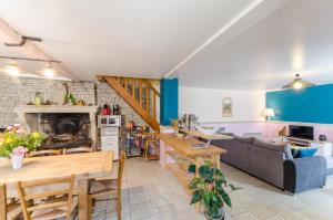 a kitchen and living room with a couch and a table at La clémenceraie in Baroville