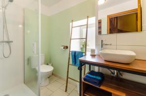 a bathroom with a sink and a toilet at La clémenceraie in Baroville +14 photos