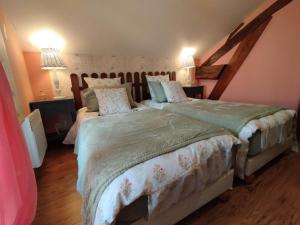 a bedroom with two beds and two lamps at La clémenceraie in Baroville