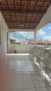 a group of chairs sitting on a patio at Casa Harmonia in Trairi
