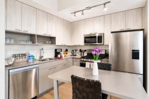 a kitchen with a table with a vase of flowers on it at Luxury Apartment In Harbor Point in Stamford