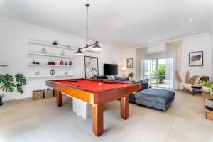 a living room with a pool table and a couch at Casa Leonor, stunning 3 bedroom villa in Carvoeiro in Praia do Carvoeiro