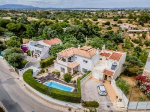 an aerial view of a white house with a pool at Casa Leonor, stunning 3 bedroom villa in Carvoeiro in Praia do Carvoeiro