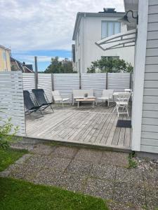 a wooden deck with chairs and a table on a house at Tiny House! in Västervik