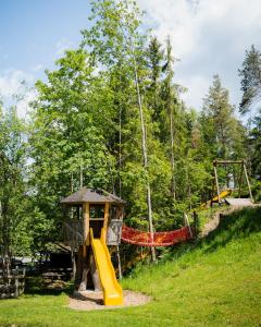 a playground in a park with a slide at Bio Bauernhof Leitenmüller in Ramsau am Dachstein