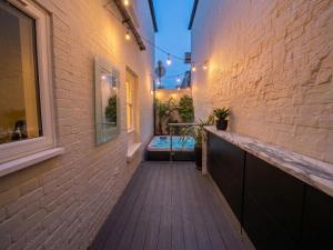 a walkway leading to a hot tub in a building at Hastings House 9-Bedroom Holiday House in Hastings