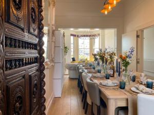 a large dining room with a long table with chairs at Hastings House 9-Bedroom Holiday House in Hastings