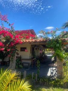 a house with a bunch of flowers on it at Pousada rancho sol nascente in Tutóia +29 photos