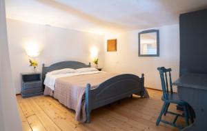 a bedroom with a bed and a table and a chair at Agriturismo Fara del Falco in Vieste +114 photos