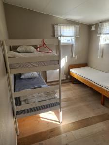 a room with two bunk beds and a bed at Sommens Camping in Sommen