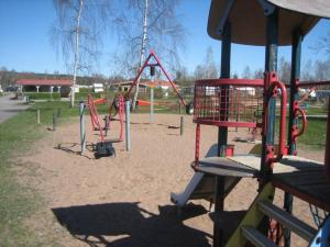 a park with a playground with slides and swings at Sommens Camping in Sommen