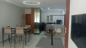 a room with a table and chairs and a fan at رويال جاردن سويت in Cairo