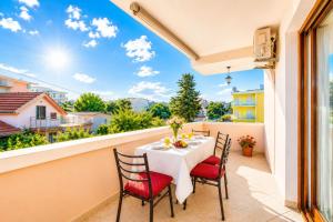a patio with a table and chairs on a balcony at Apartments Taida in Dobra Voda