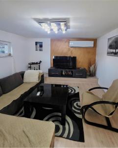 a living room with a couch and a table at G - Apartments in Kumanovo