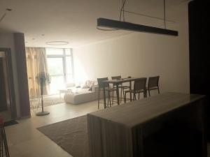 a living room with a table and chairs and a couch at رويال جاردن سويت in Cairo