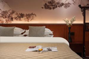 a bed with a tray with a book and a candle on it at 木老爷客栈 in Lijiang