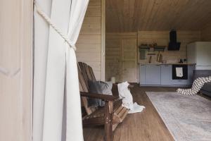 a living room with a couch and a chair at Obuoliu sala Moletu Vila in Gaylyunay +34 photos
