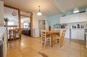 a kitchen and dining room with a table and chairs at La gentilhommière in Villemorien