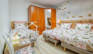 a bedroom with two beds and a mirror at La gentilhommière in Villemorien