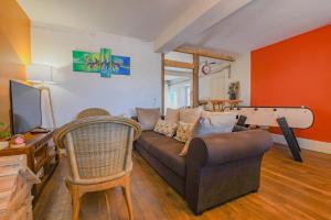 a living room with a couch and a pool table at La gentilhommière in Villemorien