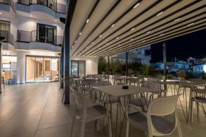a restaurant with tables and chairs on a balcony at Zurich Hotel in Ksamil
