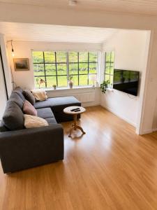 a living room with a couch and a table at Saksun Mountain & Beach Cottage in Saksun