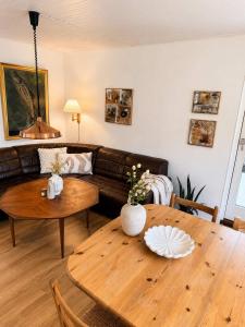 a living room with a couch and a wooden table at Saksun Mountain & Beach Cottage in Saksun