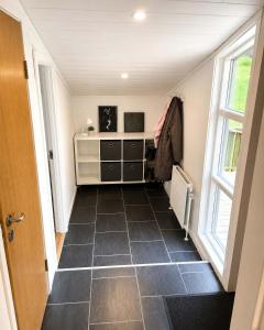 a hallway with a room with a dresser and a window at Saksun Mountain & Beach Cottage in Saksun