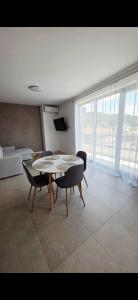 a living room with a table and chairs and a couch at CIty view apartment in Gotse Delchev