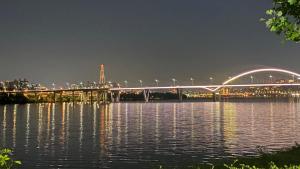 a bridge over a body of water at night at YuYu stay in Seoul