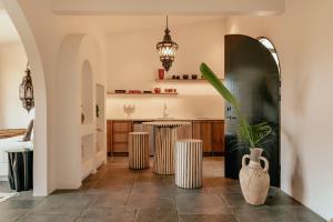 a living room with a table and two vases at Domo Nosara Boutique Hotel in Nosara