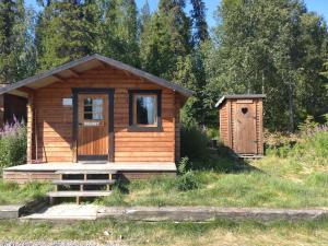 a wooden cabin with a door and a smallshed at JVT Cabins in Kiruna +8 photos