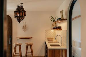 a kitchen with two stools and a sink at Domo Nosara Boutique Hotel in Nosara +33 photos