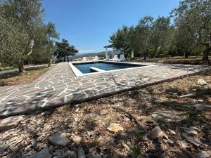 a swimming pool in the middle of a yard at Villa Natali in Pridraga