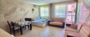 a living room with a couch and a table at Алекс 2 in Pomorie