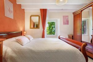 a bedroom with a bed and a window at Le Duzon avec Piscine in Saint-Sylvestre +30 photos