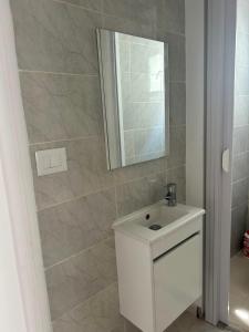 a bathroom with a white sink and a mirror at Chez Brahim in Ariana +15 photos