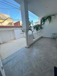 an empty room with a balcony with a pillar at Chez Brahim in Ariana