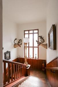 a room with a staircase and a window with antlers on the wall at Zámeček Rozkoš in Střížovice
