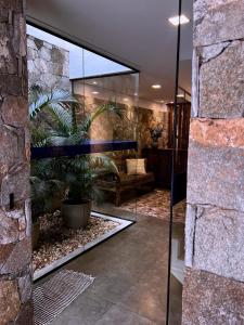 a lobby with a glass door with a plant in it at Pousada Pouso de Laura in Tiradentes +71 photos