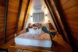 a bed with flowers on it in a room at Sunset Hill Resort in Kandy