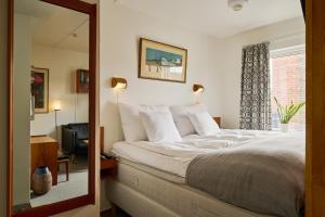 a bedroom with a large bed and a window at Hotell Hanöbris på Kivik in Kivik +57 photos
