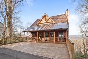 a home with a deck and a house at Misty Ridge Retreat in Blowing Rock