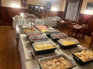 a buffet with many trays of food on a table at Hindenburg-Dependance Hotel Krone in Bad Gastein