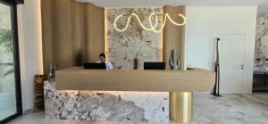 a woman sitting at a desk in an office at Veranda Hotel by Mirage in Ksamil +54 photos