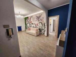 a living room with a white couch and a blue wall at Casetta Lungomare in Pescara