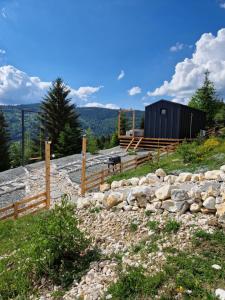 a stone path with a fence and a building at Veya Cabins Apuseni in Trifeşti