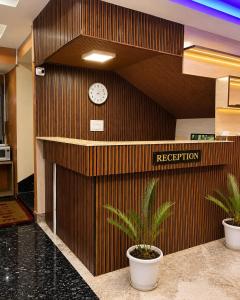 a hotel lobby with a clock on the wall at The Bliss Hotel and Restaurant in Gangtok