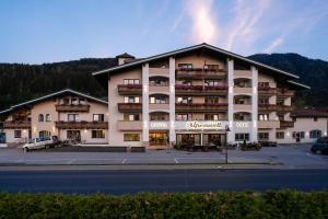 a large apartment building with a parking lot at Hotel Alpenwelt Superior in Flachau
