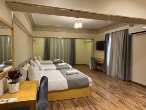 a large bedroom with a large bed and a desk at Dyafa Pyramids Hotel in Cairo +40 photos